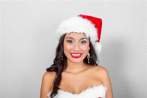 Premium Photo Brunette Latina Woman With Hat And Santa Claus Dress In