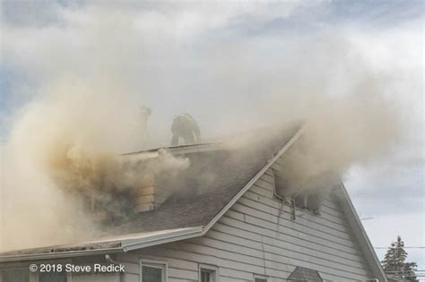 Firefighters Ventilating A Roof