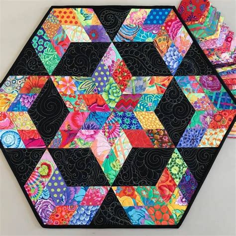 A Patchwork Table Top With Colorful Designs On It