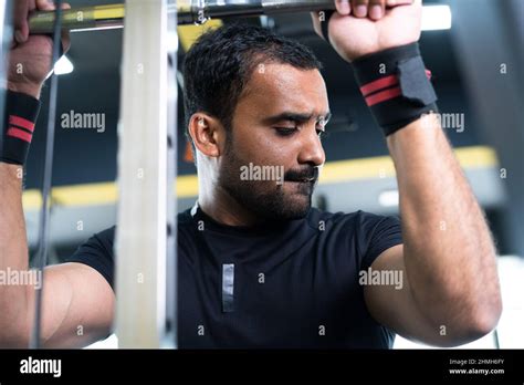 Young Indian Bodybuilder Doing Biceps Workout At Gym Concept Of Body