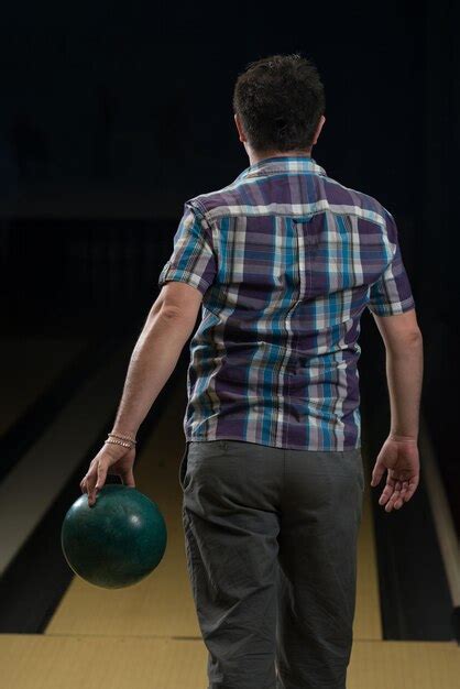 Premium Photo Man Holding A Bowling Ball