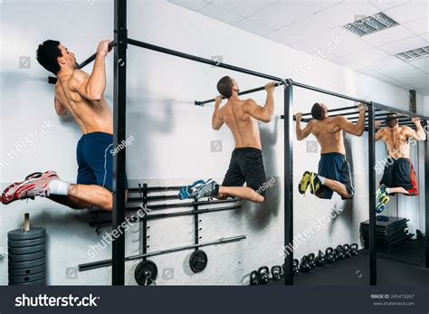 Group Muscular Men Doing Pull Ups Stock Photo Edit Now 245419267