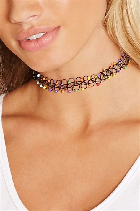 A Tattoo Choker Adorned With Multicolored Beads Chokers Tattoo Choker Necklace