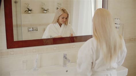 Beautiful Blonde Woman Brushing Her Teeth In The Bathroom Stock Video
