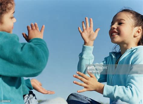 Two Girls Playing A Clapping Game High Res Stock Photo Getty Images