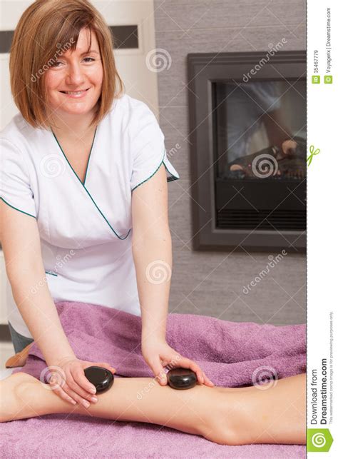 Beauty Salon Woman Getting Spa Hot Stone Legs Massage Stock Image