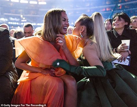 Chrissy Teigen Showers Ariana Grande In Kisses Behind The Scenes At The