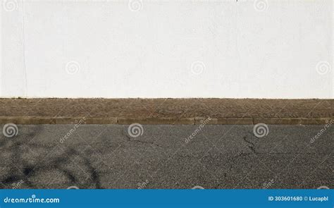 High White Plaster Wall With Porphyry Sidewalk And Street In Front
