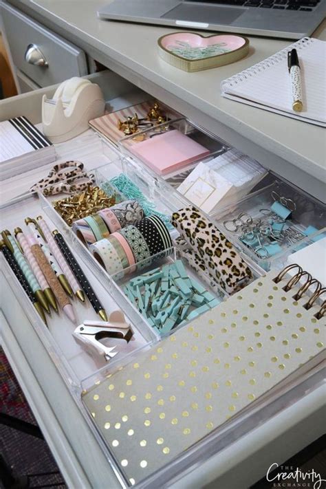 An Organized Drawer With Lots Of Items In It And A Laptop On The Desk