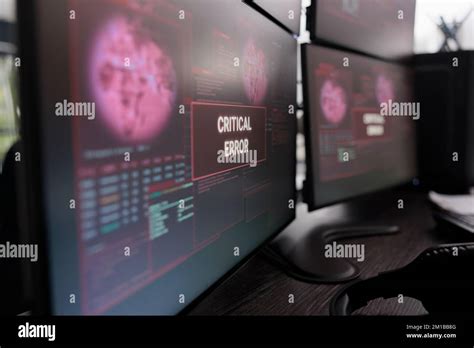 Multiple monitors showing critical error message after cyber crime