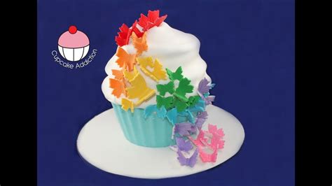 Add the milk to get the cake mix to a soft dropping consistency, where a heaped spoonful of mixture falls off the spoon after tipping. Giant Rainbow Butterfly Cupcake - How to Decorate your ...
