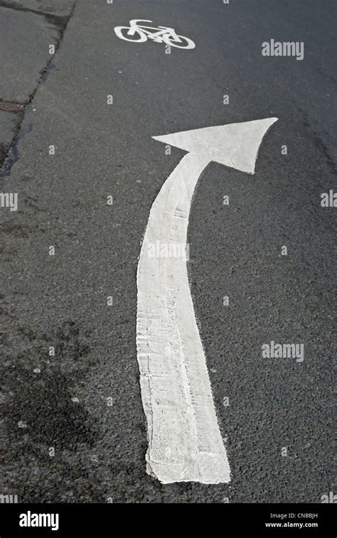 British Road Marking In Form Of Right Curving Arrow With Cycle Marking