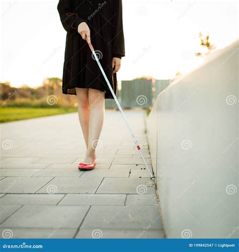 Blind Woman Walking On City Streets Using Her White Cane Stock Image