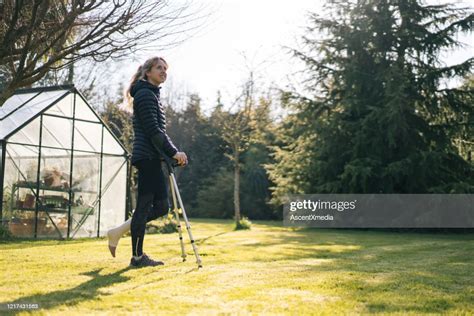 Young Woman On Crutches Relaxes In Garden High Res Stock Photo Getty