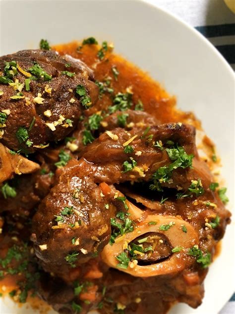 It's a milanese dish of veal shanks braised with wine, vegetables and stock until the meat is falling off the bone. Osso Buco Beef Shank and Gremolata Recipe | Amiable Foods
