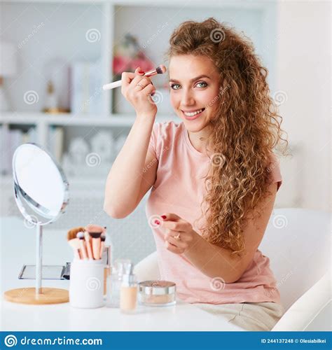 Beautiful Young Woman Applying Makeup On Home Skin Care Stock Photo