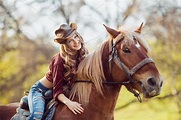 Beautiful smiling girl riding horse on autumn field | High-Quality ...