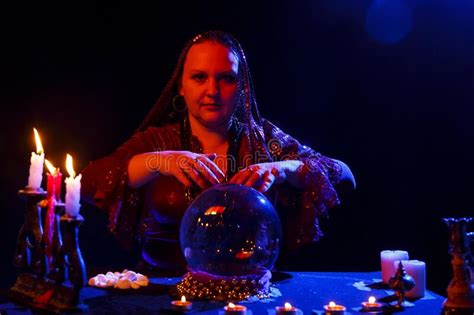 A Young Fortune Teller In The Salon Reads Fortunes On A Magic Crystal