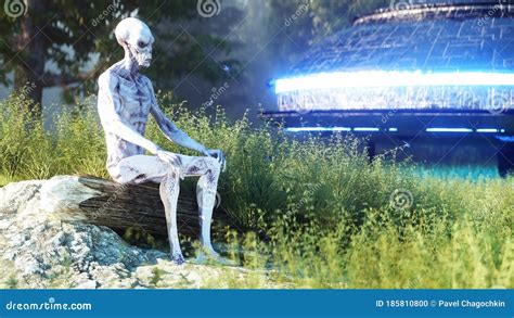 Alien Man Sitting In Front Of A Desert Outpost Royalty Free Stock