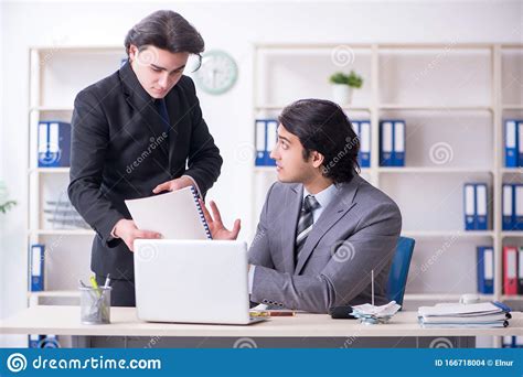 Two Young Employees Working In The Office Stock Photo Image Of