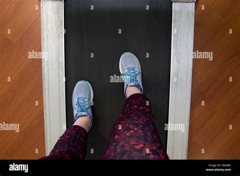 Pov Looking Down At Sneakers And Workout Pants On A Treadmill Ready To Run Stock Photo Alamy