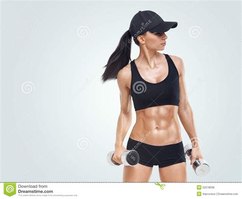 Fitness Sporty Woman In Training Pumping Up Muscles With Dumbbells