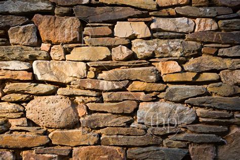 Stone Wall Built From Natural Stones And Rocks Of Different Sizes