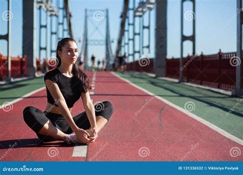 Awesome Fitness Model Doing Stretching And Preparing To Running Stock