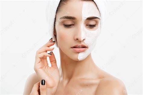 Beautiful Caucasian Woman Face Portrait Applying Cream Mask On Her