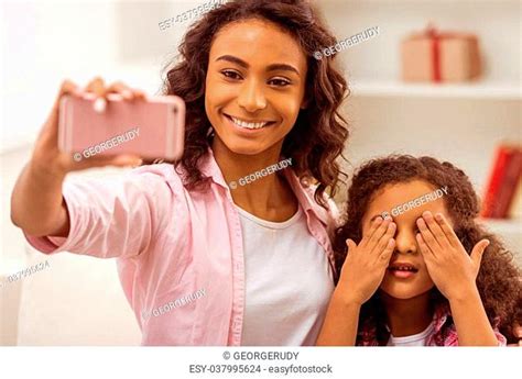 Daughter Covering Her Mother Eyes Stock Photos And Images Agefotostock