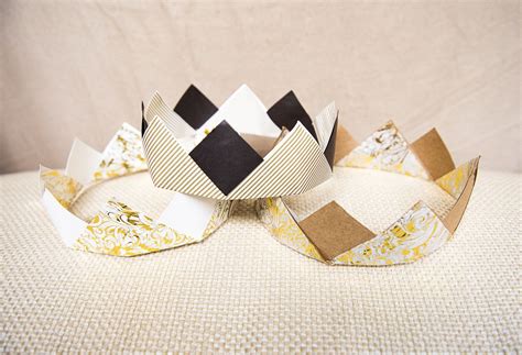 Two Paper Crowns Sitting On Top Of Each Other