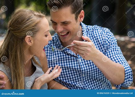 Smiling Man Feeding Woman At Outdoor Restaurant Stock Image Image Of