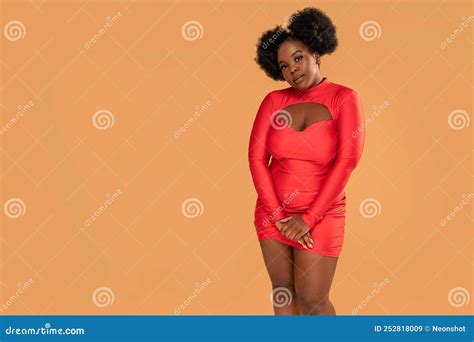 Beautiful African Woman Posing In Red Mini Dress Looking At The Camera