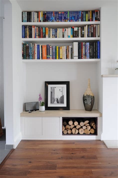 Coloful wall with many books on book shelves in a modern living room blurred, retro interior. Alcove Log Storage And Book Shelves