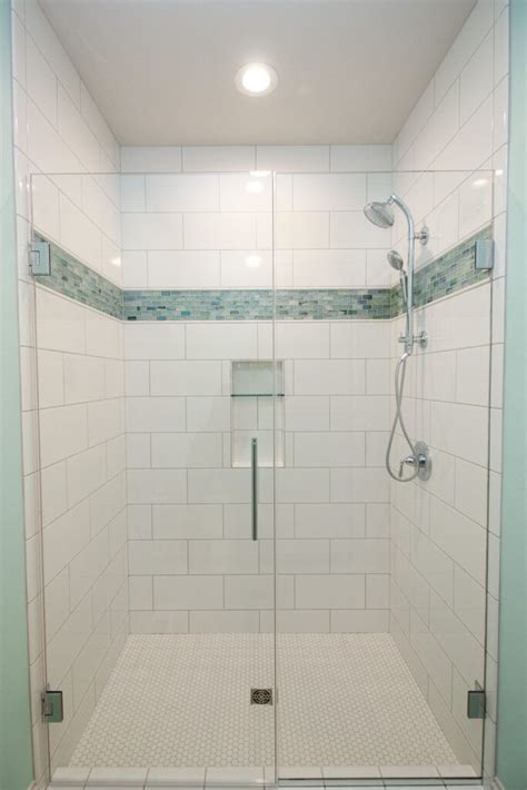 White Tiled Shower With Aqua Mosaic Accent Strip And Glass Shower Door