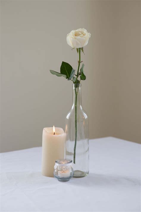 A Single White Rose And Candles For A Simple Centrepiece