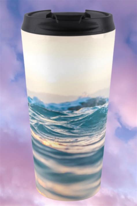 A Coffee Cup With An Ocean Scene On The Front Is Shown Against A Purple