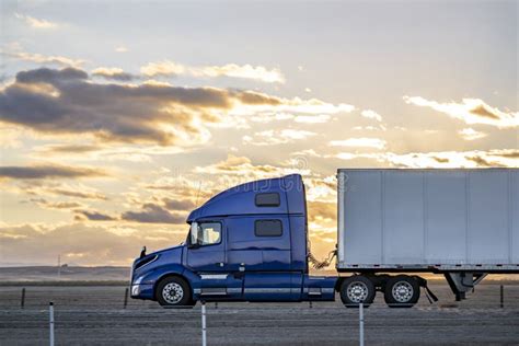 Profile Of Big Rig Blue Semi Truck Tractor With Dry Van Semi Trailer