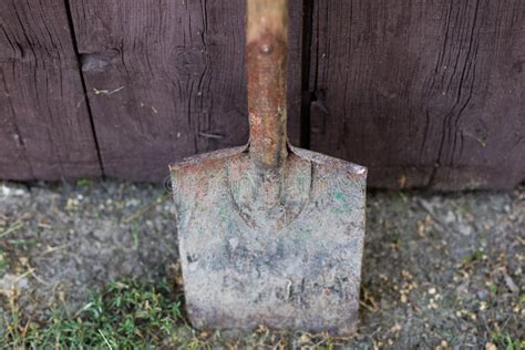 An Old Garden Spade Leaning Against A Wooden Door Tools For Working In