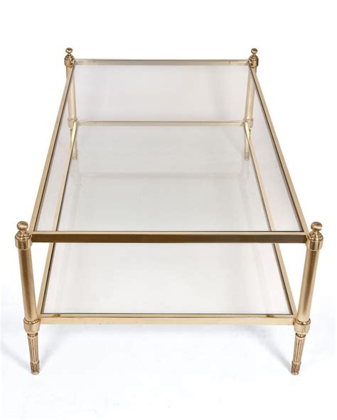 This is a mid c20th brass and glass top coffee table. Maison Jansen Brass and Glass Coffee Table at 1stdibs
