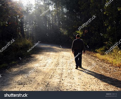 Man Walking Dirt Road Late Afternoon Stock Photo 1085110 Shutterstock