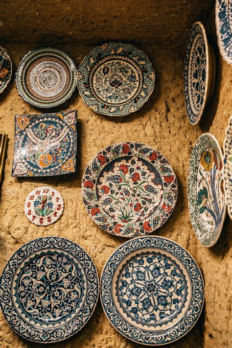 Bright Decorative Ceramic Plates With Ornaments On Stone Wall · Free