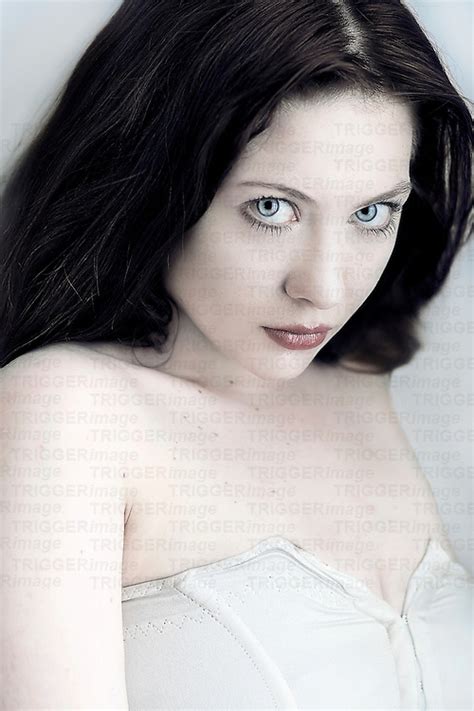 A white person can have black hair. Young woman with long dark hair looking shy at camera ...
