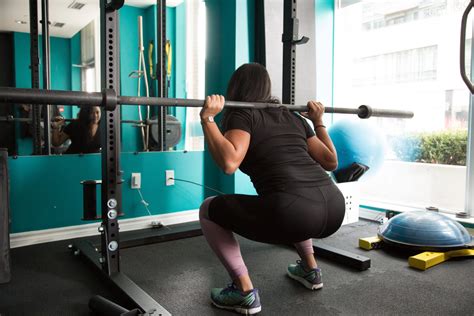 Woman Squatting Home Gym The Better Butt Challenge