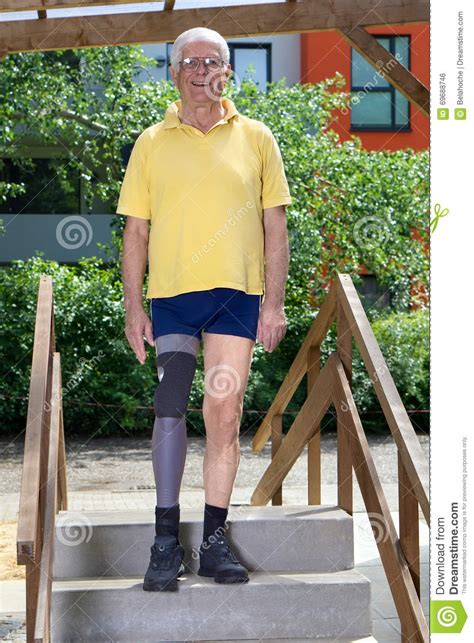 Senior Leg Amputee Standing On Staircase Of Training Course For