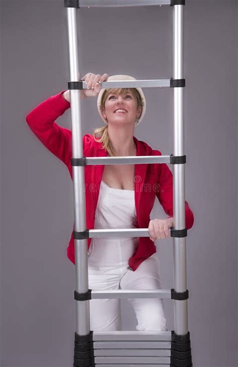 Woman Wearing A Hard Hat And Holding A Telescopic Ladder Stock Photo Image Of Female