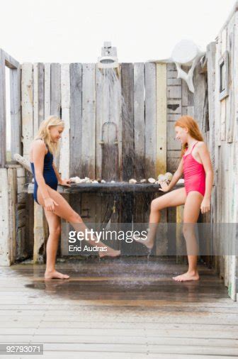 Two Girls Under A Beach Shower Bildbanksbilder Getty Images