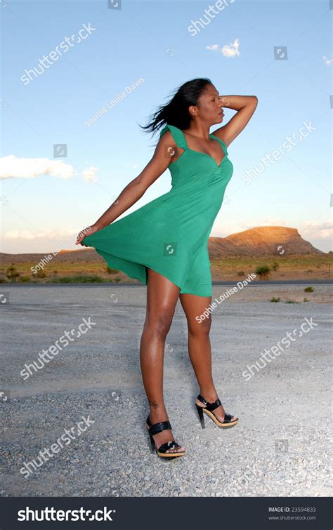 Beautiful African American Woman Wearing A Green Summer Dress In The