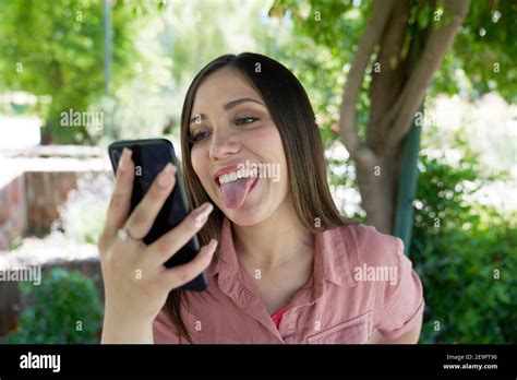 A Beautiful White Latina Woman Sticking Her Tongue Out On A Video Call