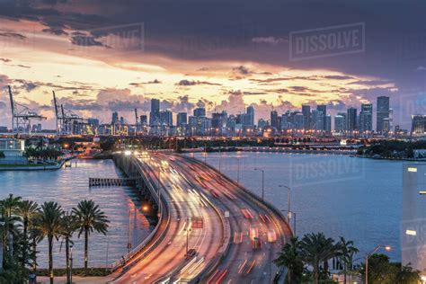 Miami Skyline At Dusk Traffic On Macarthur Causeway Florida Usa